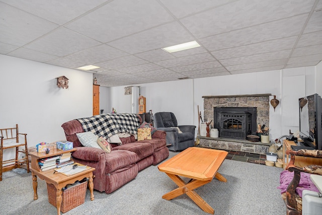 carpeted living area featuring a drop ceiling