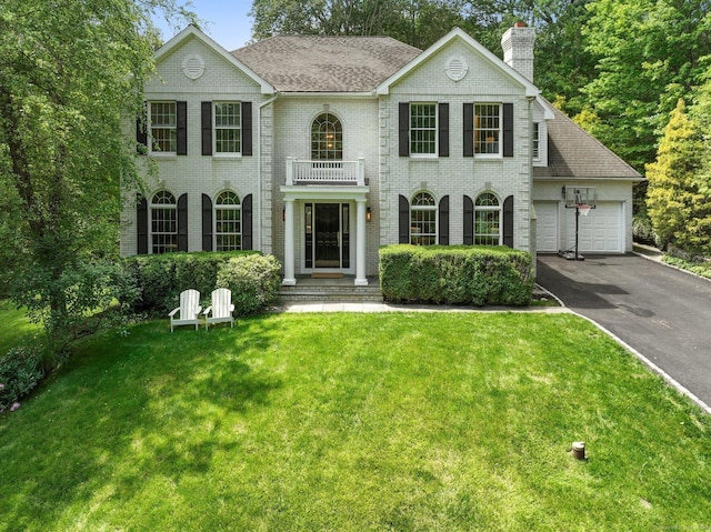 681 Old Stamford Rd, New Canaan, CT 06840 - georgian-style home with a balcony, driveway, a garage, brick siding, and a chimney