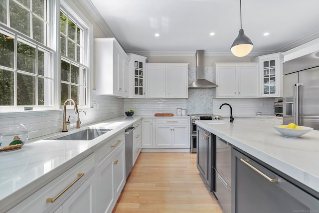 681 Old Stamford Rd, New Canaan, CT 06840 - kitchen featuring wall chimney range hood, a sink, plenty of natural light, crown molding, and white cabinets