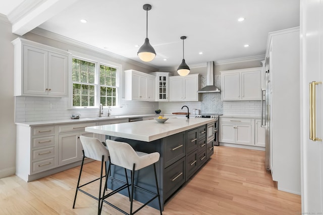 681 Old Stamford Rd, New Canaan, CT 06840 - kitchen with wall chimney range hood, white cabinetry, a kitchen island, crown molding, and recessed lighting