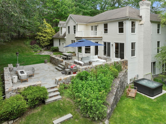 681 Old Stamford Rd, New Canaan, CT 06840 - rear view of house with a balcony, an outdoor living space, a patio area, and a lawn