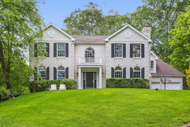 681 Old Stamford Rd, New Canaan, CT 06840 - colonial house featuring a balcony, a front yard, a chimney, and a garage