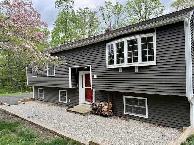 view of front of home with a chimney and a patio area
