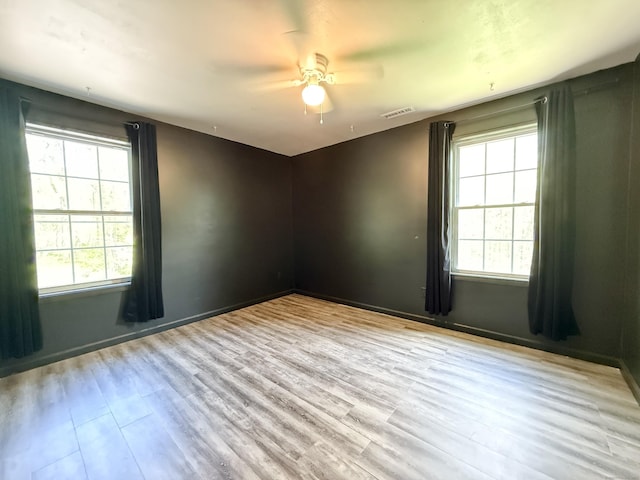 empty room with wood finished floors and a ceiling fan
