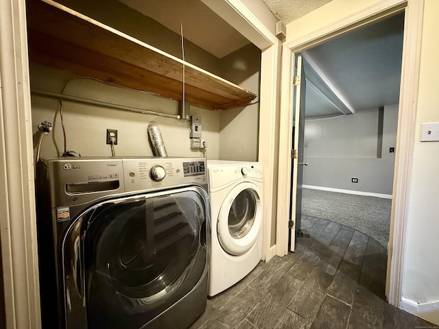 washroom with independent washer and dryer, dark wood-style floors, and baseboards