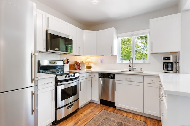 30 Elmcroft Rd Apt 12, Stamford, CT 06902 - kitchen with stainless steel appliances, a sink, decorative backsplash, and light countertops