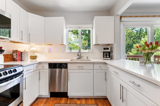 30 Elmcroft Rd Apt 12, Stamford, CT 06902 - kitchen with stainless steel appliances, a sink, white cabinets, and light countertops