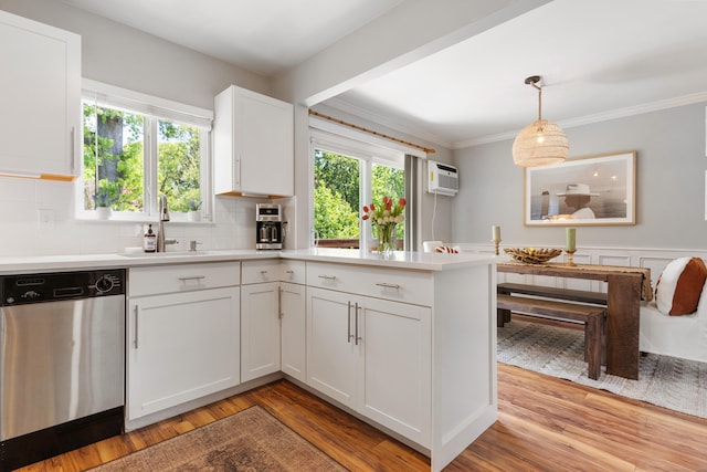 30 Elmcroft Rd Apt 12, Stamford, CT 06902 - kitchen featuring stainless steel dishwasher, a sink, light countertops, white cabinets, and a peninsula
