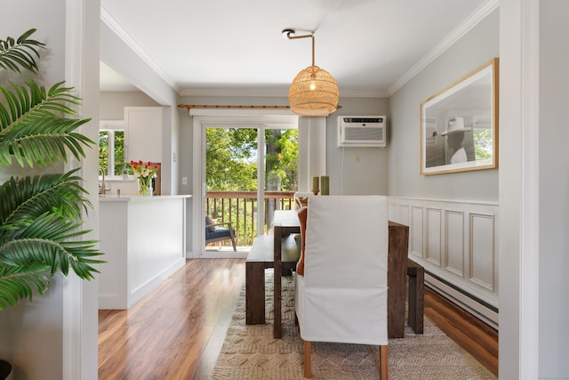 30 Elmcroft Rd Apt 12, Stamford, CT 06902 - dining room with baseboard heating, light wood finished floors, an AC wall unit, and crown molding