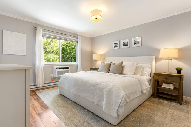 30 Elmcroft Rd Apt 12, Stamford, CT 06902 - bedroom featuring ornamental molding, a wall mounted AC, wood finished floors, and a baseboard heating unit