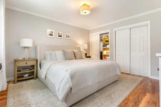 30 Elmcroft Rd Apt 12, Stamford, CT 06902 - bedroom with ornamental molding, wood finished floors, baseboards, and two closets