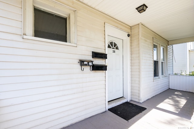 view of exterior entry featuring a porch
