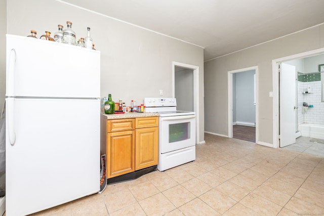 kitchen with white appliances, light tile patterned floors, and light countertops