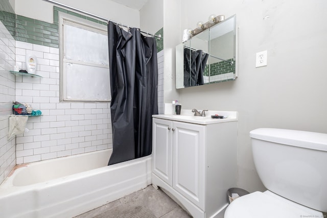 bathroom featuring toilet, shower / tub combo with curtain, and vanity