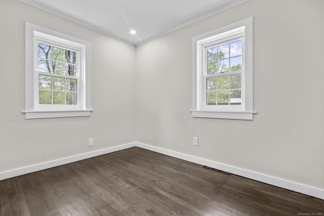 unfurnished room with baseboards, dark wood finished floors, and ornamental molding