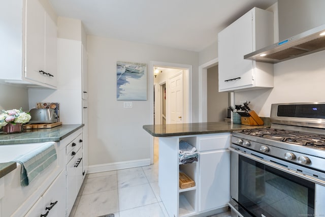 85 5th St, Stamford, CT 06905 - kitchen with gas stove, wall chimney exhaust hood, light marble finish flooring, and white cabinets