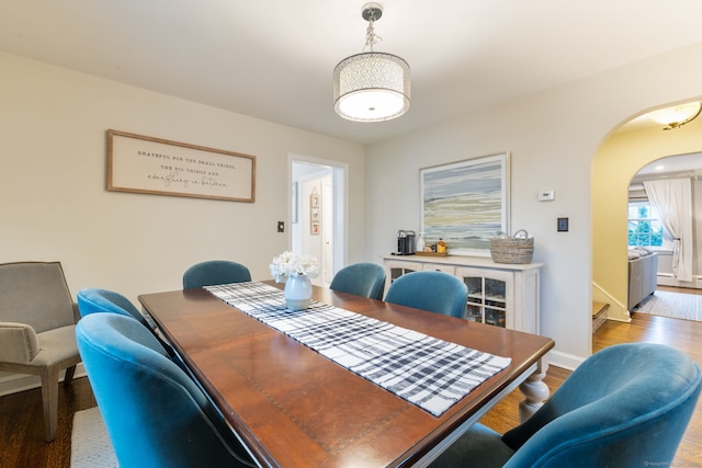 85 5th St, Stamford, CT 06905 - dining room featuring arched walkways, wood finished floors, and baseboards