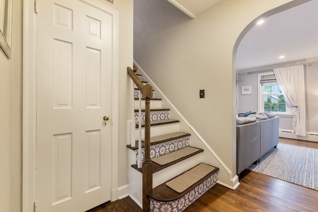 85 5th St, Stamford, CT 06905 - stairway featuring arched walkways, wood finished floors, a baseboard radiator, baseboards, and recessed lighting