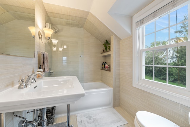 85 5th St, Stamford, CT 06905 - bathroom featuring tile walls, toilet, plenty of natural light, vaulted ceiling, and a bathtub