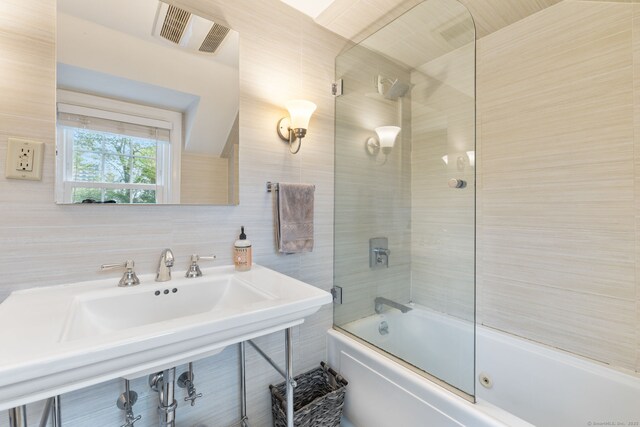 85 5th St, Stamford, CT 06905 - full bathroom with combined bath / shower with glass door, tasteful backsplash, and tile walls
