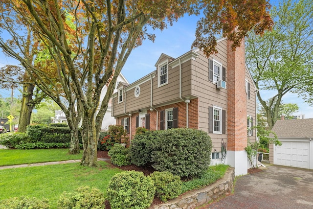85 5th St, Stamford, CT 06905 - view of front of home with a chimney, a front lawn, and an outdoor structure
