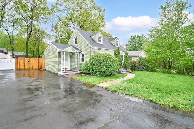 view of front of home with driveway and a shingled roof