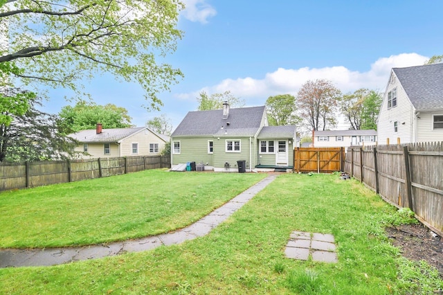 back of property with a chimney