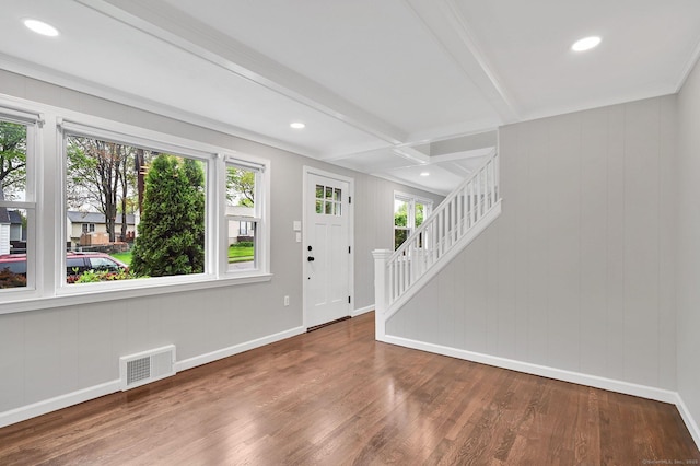 entryway featuring plenty of natural light, wood finished floors, baseboards, beamed ceiling, and stairway
