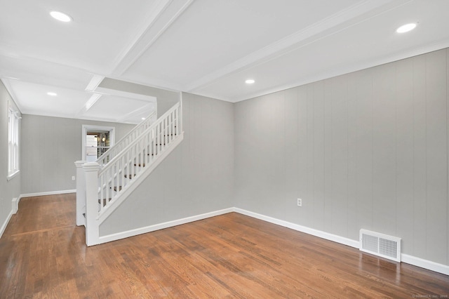 spare room with stairs, wood finished floors, baseboards, beam ceiling, and recessed lighting