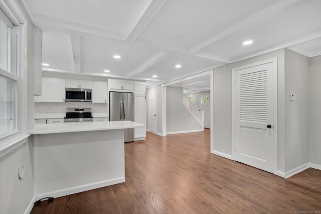 kitchen with stainless steel appliances, baseboards, white cabinetry, wood finished floors, and recessed lighting