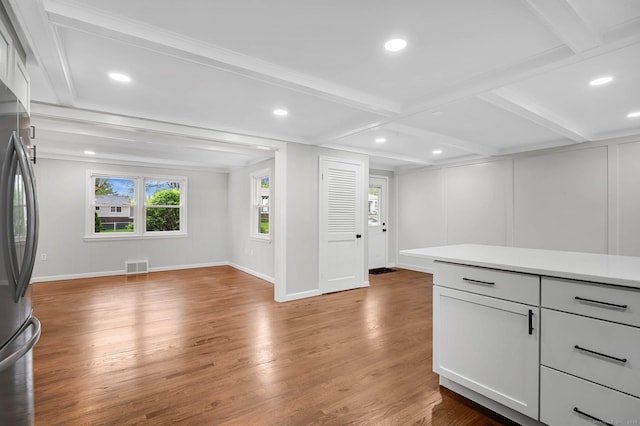 kitchen with freestanding refrigerator, light countertops, wood finished floors, open floor plan, and recessed lighting