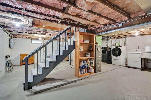 basement with washer and clothes dryer, stairway, and electric panel