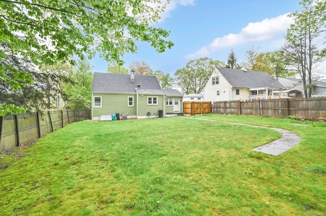 rear view of property featuring a chimney and central AC