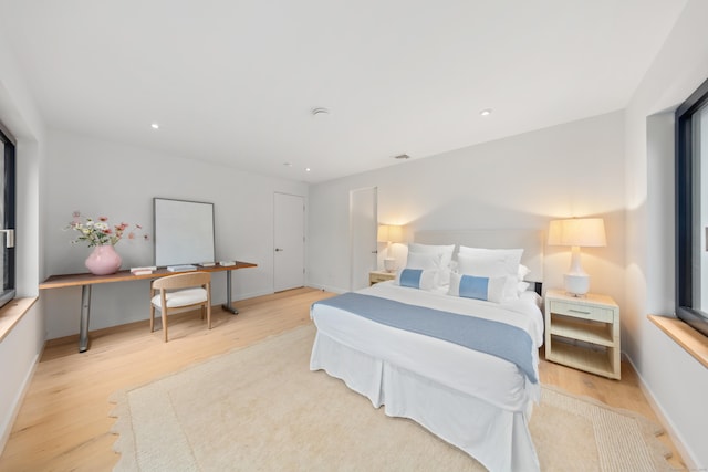 bedroom featuring light wood finished floors, baseboards, an office area, and recessed lighting