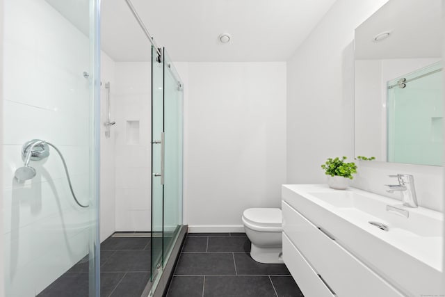 bathroom featuring a stall shower, toilet, vanity, tile patterned flooring, and baseboards