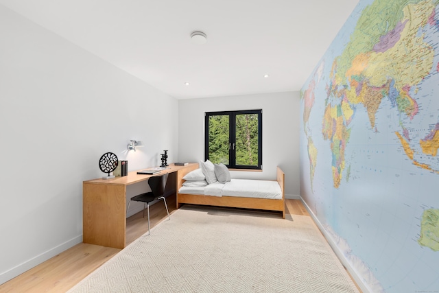 bedroom with light wood-style floors, baseboards, and recessed lighting