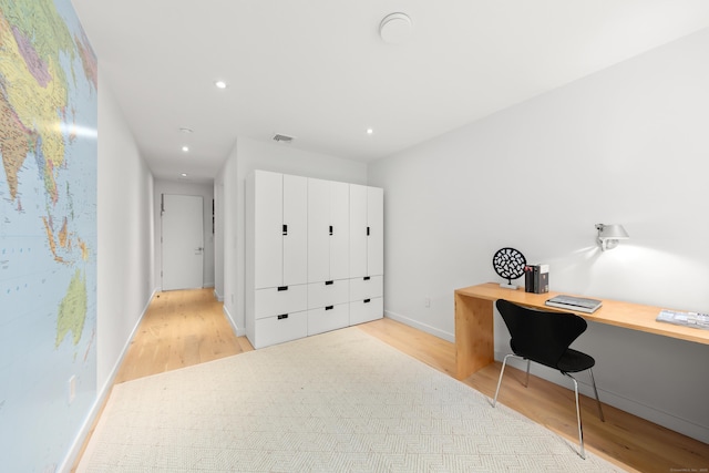 home office with light wood finished floors, recessed lighting, baseboards, and built in study area
