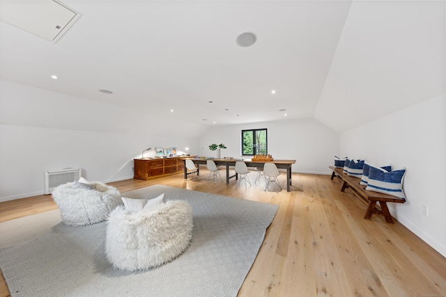 rec room featuring vaulted ceiling, light wood-style floors, and baseboards