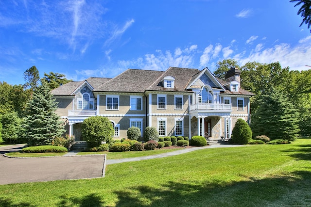 88 Merry Meet Cir, Fairfield, CT 06824 - view of front of property with a balcony, a front lawn, and a chimney