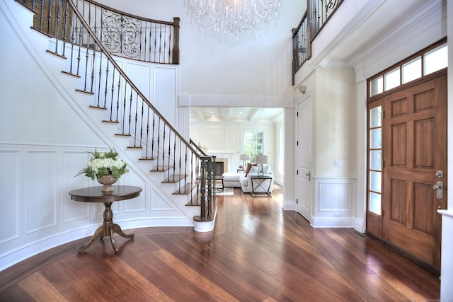 88 Merry Meet Cir, Fairfield, CT 06824 - foyer entrance featuring a decorative wall, stairway, plenty of natural light, a towering ceiling, and wood finished floors