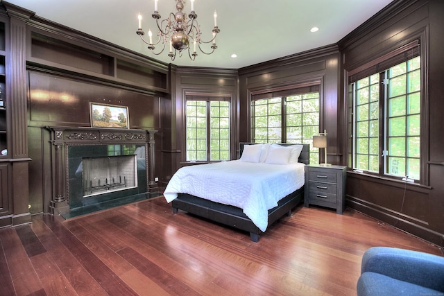88 Merry Meet Cir, Fairfield, CT 06824 - bedroom with crown molding, a chandelier, a decorative wall, a fireplace, and wood finished floors