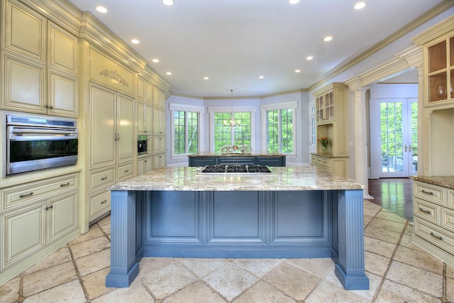 88 Merry Meet Cir, Fairfield, CT 06824 - kitchen featuring cream cabinets, appliances with stainless steel finishes, a center island with sink, plenty of natural light, and crown molding
