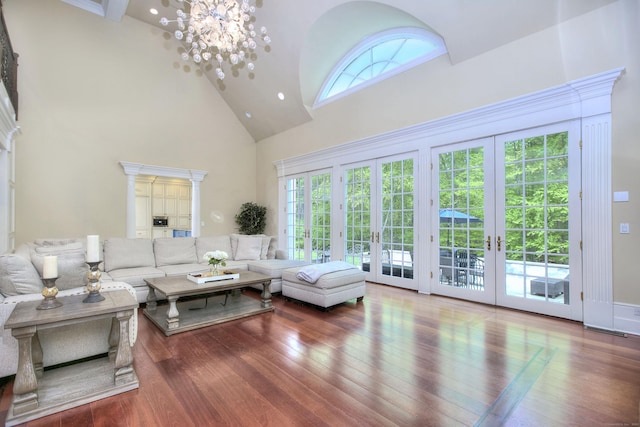 88 Merry Meet Cir, Fairfield, CT 06824 - living area featuring high vaulted ceiling, french doors, wood-type flooring, and a chandelier