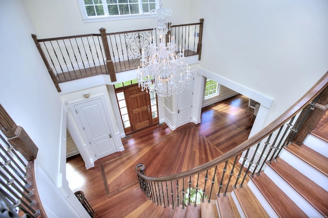88 Merry Meet Cir, Fairfield, CT 06824 - staircase featuring a chandelier, a towering ceiling, and wood finished floors