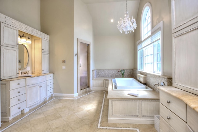 88 Merry Meet Cir, Fairfield, CT 06824 - bathroom featuring high vaulted ceiling, a chandelier, vanity, a garden tub, and baseboards