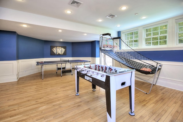 88 Merry Meet Cir, Fairfield, CT 06824 - recreation room featuring a decorative wall, a wainscoted wall, light wood-style floors, and recessed lighting