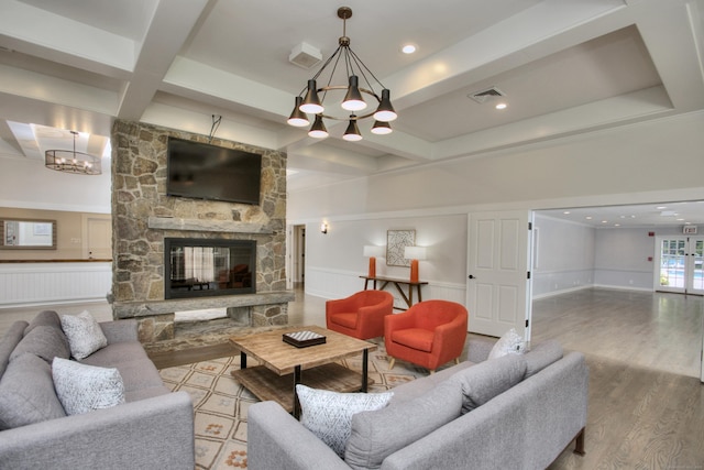 88 Merry Meet Cir, Fairfield, CT 06824 - living area with a chandelier, coffered ceiling, wood finished floors, a wainscoted wall, and beam ceiling