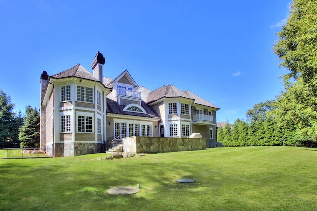 88 Merry Meet Cir, Fairfield, CT 06824 - rear view of house featuring a lawn, stone siding, and a chimney