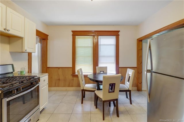 19 5th St, Ansonia, CT 06401 - dining room with a wainscoted wall, wooden walls, and light tile patterned flooring