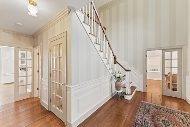 1 Dover Cir, Newtown, CT 06470 - entrance foyer with hardwood / wood-style flooring, stairs, crown molding, wallpapered walls, and a decorative wall